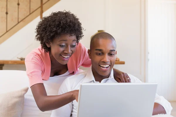 Söta par avkopplande soffan med laptop — Stockfoto