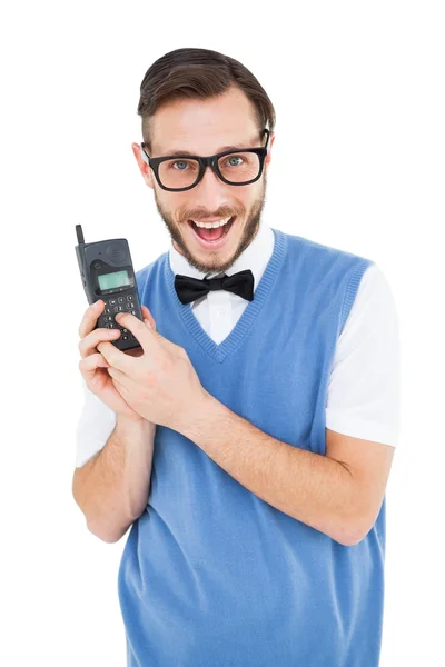 Geeky hipster segurando um celular retro — Fotografia de Stock