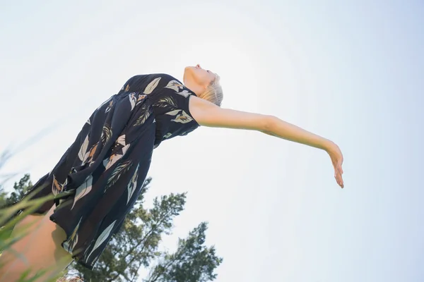 Bonita rubia en vestido de sol de pie con los brazos fuera — Foto de Stock