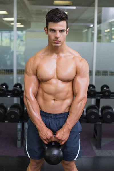 Gespierde man tillen waterkoker bell in gym — Stockfoto