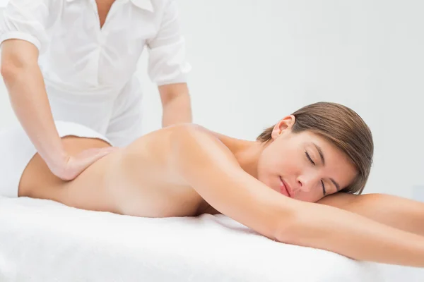 Attractive young woman receiving back massage at spa center — Stock Photo, Image