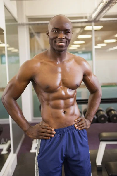 Smiling shirtless muscular man with hands on hips — Stock Photo, Image