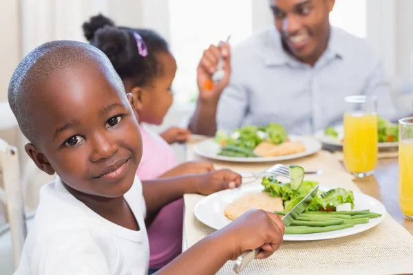 Rodina těší zdravé jídlo spolu se synem se usmívá na přišel — Stock fotografie