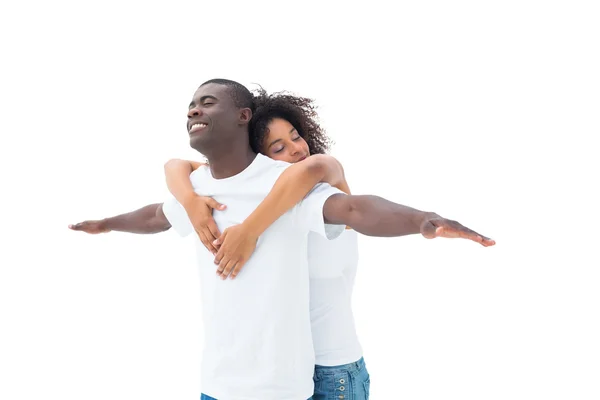 Casual couple standing with arms outstretched — Stock Photo, Image