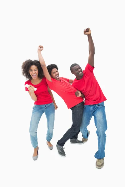 Football fans in red cheering together — Stock Photo, Image