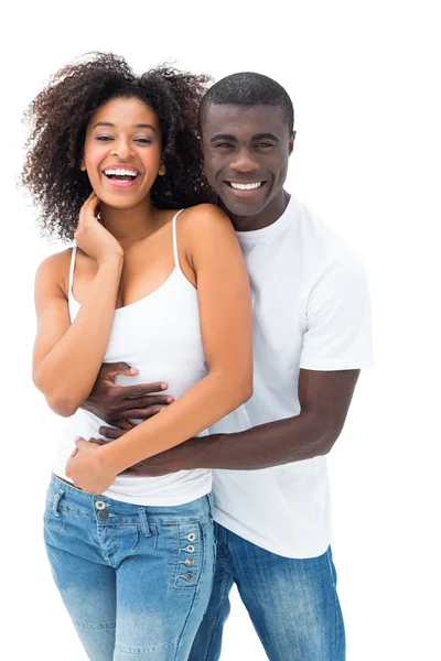 Casual couple embracing and smiling at camera — Stock Photo, Image