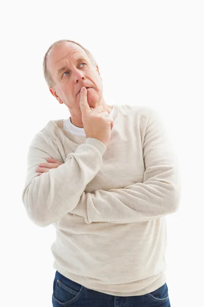 Thinking mature man with hand on chin Stock Picture