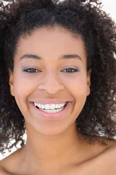 Pretty girl with afro hairstyle smiling at camera Stock Picture