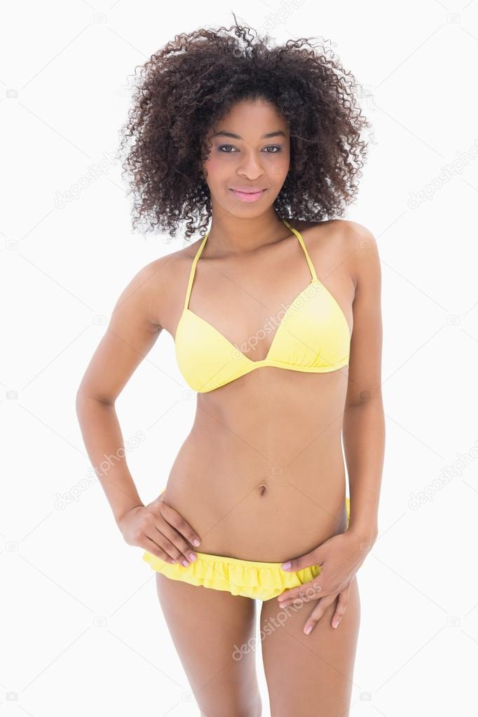 Athletic girl in yellow bikini smiling at camera Stock Photo Wavebreakmedia 50046415