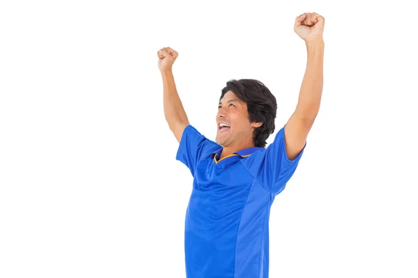 Ποδοσφαιριστής στην μπλε Γιορτάζοντας μια νίκη — Φωτογραφία Αρχείου