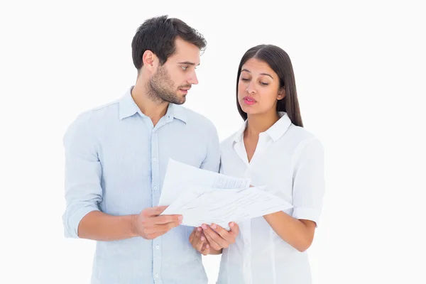 Atraente jovem casal segurando uma casa modelo — Fotografia de Stock