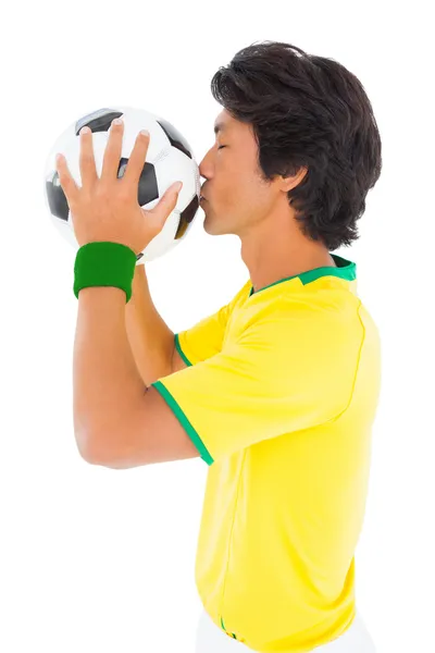 Futbolcu sarı topu öpüyor — Stok fotoğraf