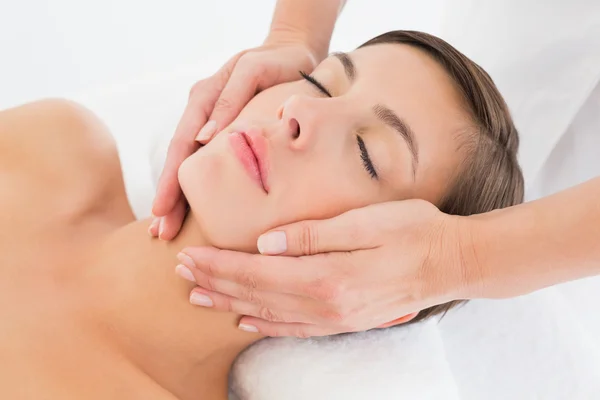 Attractive young woman receiving facial massage at spa center — Stock Photo, Image