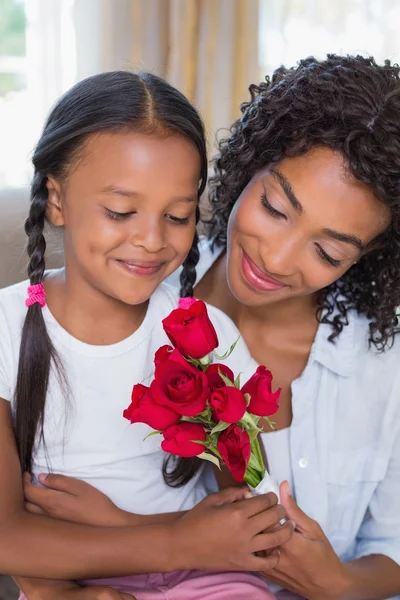 Pretty mother with her daughter holding roses — Stock Photo, Image
