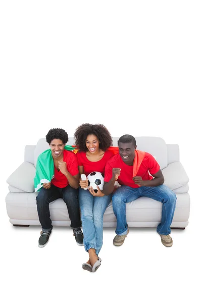 Portugal football fans in red on the sofa — Stock Photo, Image