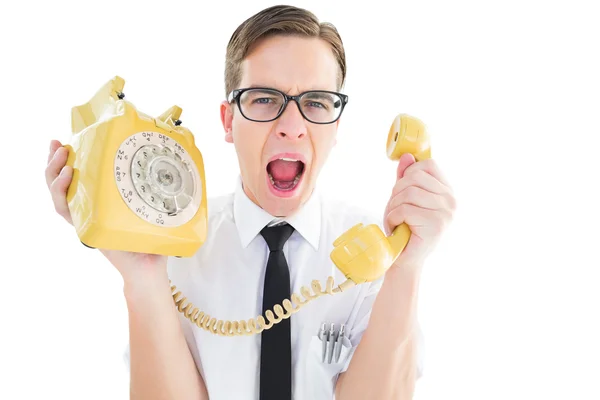 Geeky businessman shouting at retro phone — Stock Photo, Image