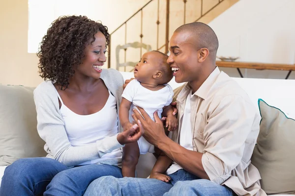 Happy young parents spending time with baby on the couch — Stock Photo, Image