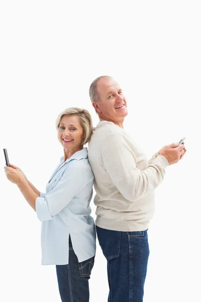 Feliz casal maduro usando seus smartphones — Fotografia de Stock
