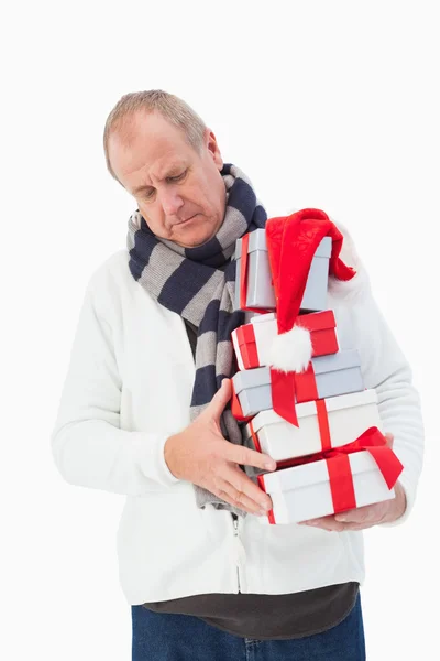 Mature man in winter clothes holding gifts — Stock Photo, Image