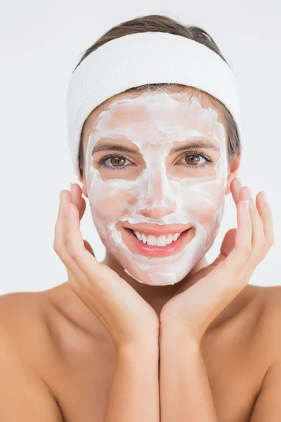 Attractive woman having white cream on her face — Stock Photo, Image