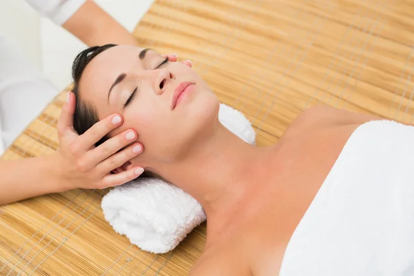 Peaceful brunette enjoying a head massage — Stock Photo, Image