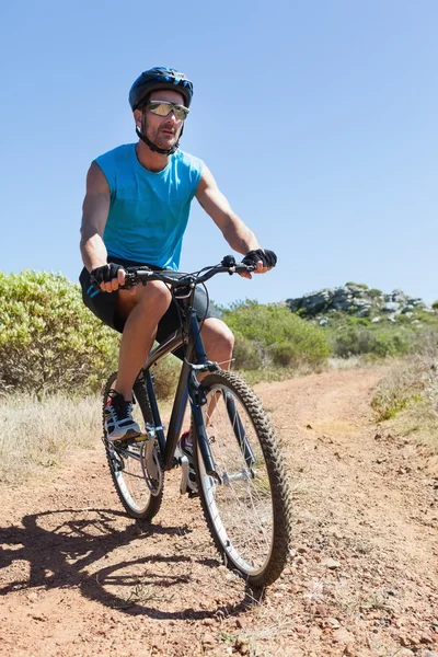 Fit cyclist riding on country trail — Stock Photo, Image