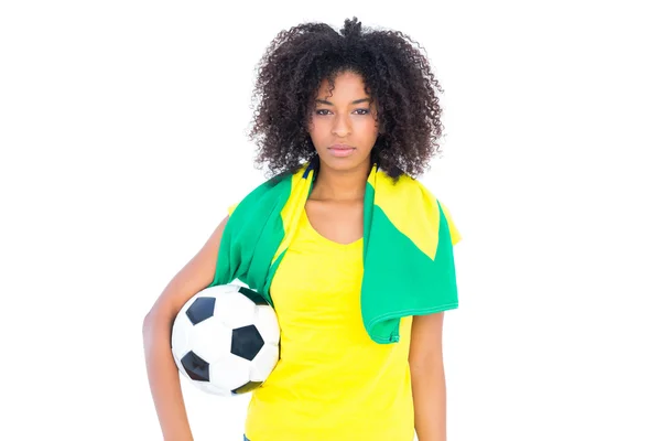 Pretty football fan holding brazilian flag looking at camera — Stock Photo, Image