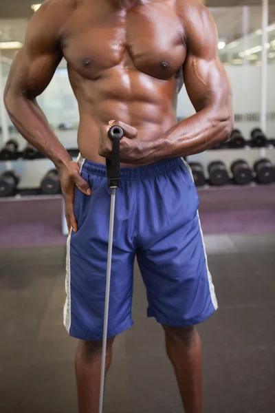 Gespierde man met weerstand band in gym — Stockfoto