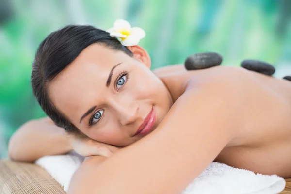 Morena disfrutando de masaje de piedra caliente —  Fotos de Stock