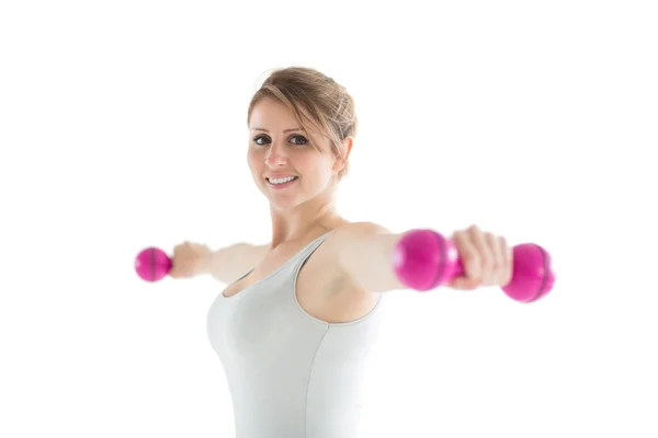 Smiling young woman with dumbbells — Stock Photo, Image