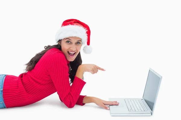 Beautiful festive woman pointing to laptop — Stock Photo, Image