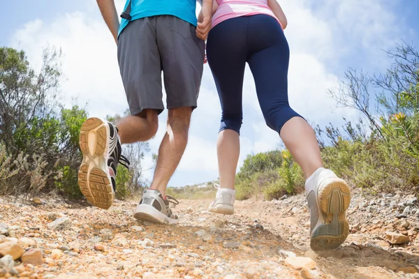 Couple running up mountain trail — Stock Photo, Image