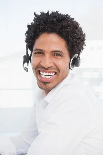 Gelukkig zakenman werken aan zijn Bureau hoofdtelefoon dragen — Stockfoto