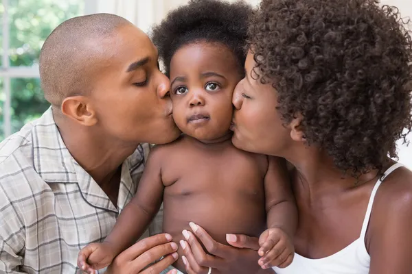 Happy couple on bed with baby daughter — Stock Photo, Image