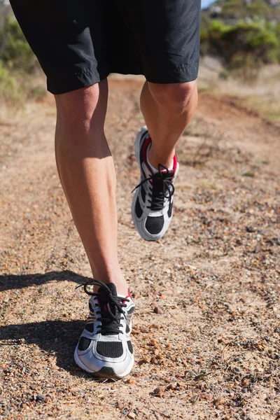 Athletic man jogging in the countryside — Stock Photo, Image