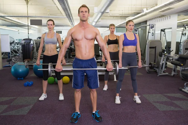 Fitness class lifting barbells together — Stock Photo, Image