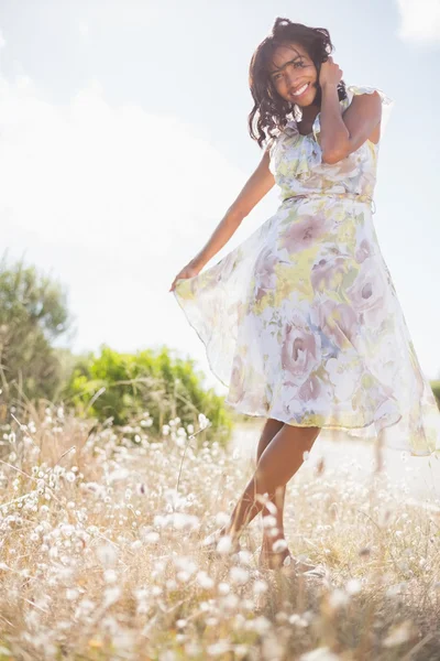 Hermosa mujer en vestido floral sonriendo a la cámara —  Fotos de Stock