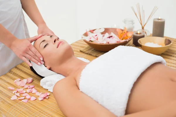 Peaceful brunette enjoying a head massage — Stock Photo, Image