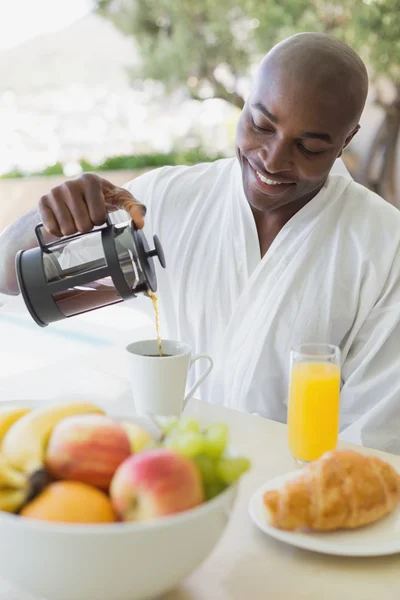 Handsome man in bathrobe having breakfast outside — Stock Photo, Image