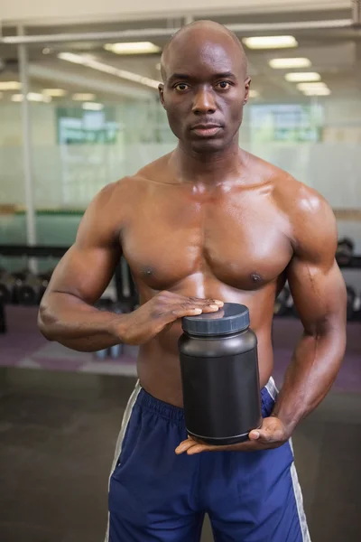 Hombre muscular con suplemento nutricional —  Fotos de Stock