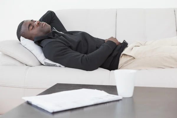 Casual man sover på hans soffa — Stockfoto