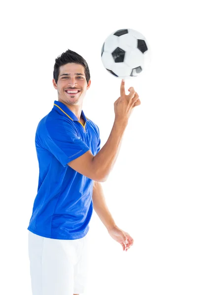 Football player in blue spinning ball — Stock Photo, Image