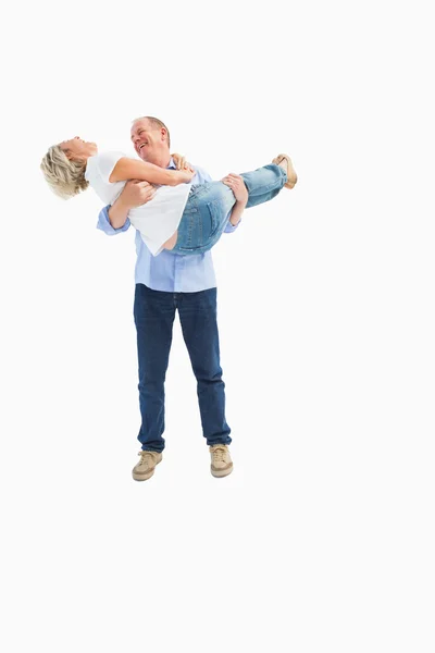 Mature man carrying his laughing partner — Stock Photo, Image