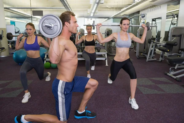 Fitness class lifting barbells together — Stock Photo, Image