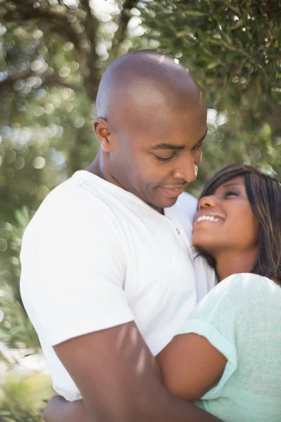 Happy couple hugging each other in garden — Stock Photo, Image