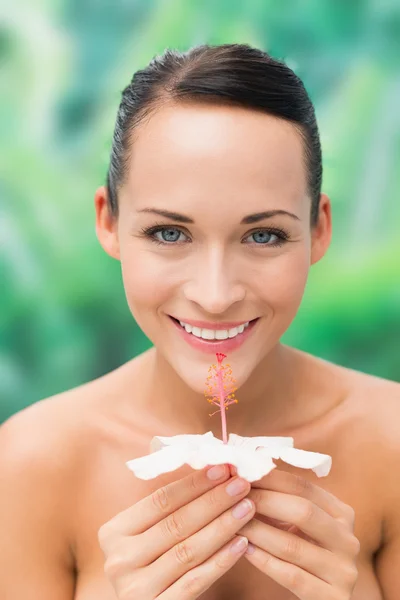 Schöne nackte Brünette riechende Lilie Blick auf Kamera — Stockfoto