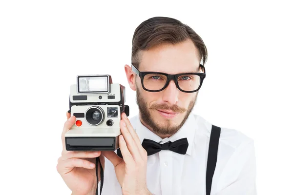 Geeky hipster sosteniendo una cámara retro — Foto de Stock