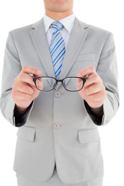 Geeky happy businessman thinking with hand on chin — Stock Photo, Image