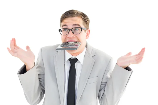 Geeky shrugging businessman biting calculator — Stock Photo, Image