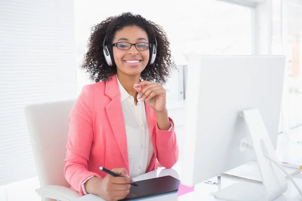 Casual graphic designer working at her desk smiling at camera — Stock Photo, Image